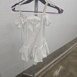 White Ruffled Dress with Bow and Floral Accents